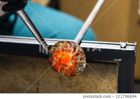 Works of a glass blowing workshop in progress. Molten glass Works of a glass blowing workshop in progress. Molten glass 121796694