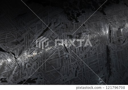 Polished dark meteorite surface with chaotic crysal pattern Polished dark meteorite surface with chaotic crysal pattern 121796708