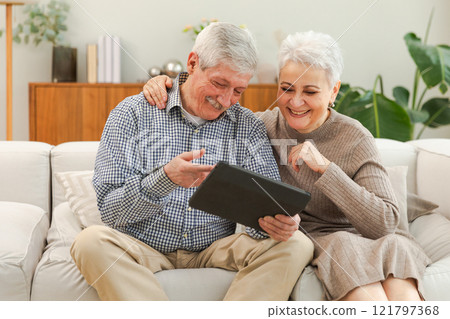 Video call. Happy senior couple woman man with tablet having video call. Mature old grandmother grandfather talking speaking online. Older generation modern tech usage. Virtual meeting online chat Video call. Happy senior couple woman man with tablet having video call. Mature old grandmother grandfather talking speaking online. Older generation modern tech usage. Virtual meeting online chat 121797368