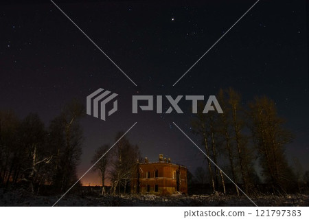 A Mysterious Abandoned Building Standing Alone Under a Starry Night Sky A Mysterious Abandoned Building Standing Alone Under a Starry Night Sky 121797383