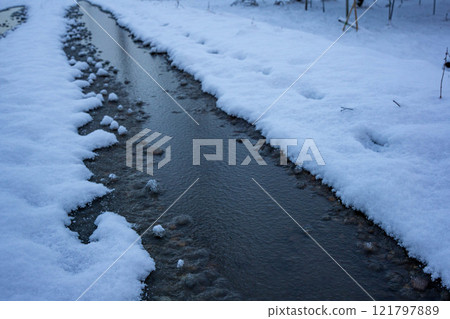 Frozen rutted farm road 121797889