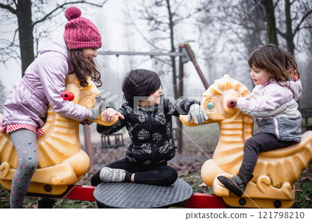 little girls playing at children's playground having fun 121798210