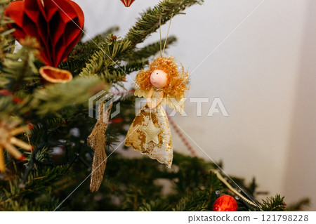 christmas tree decorated with angel and ornaments christmas tree decorated with angel and ornaments 121798228