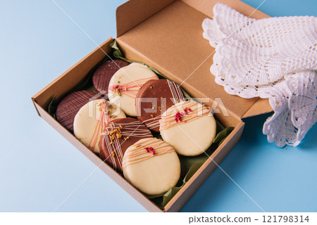Ischler cookies coated with brown and white chocolate glaze in the box 121798314