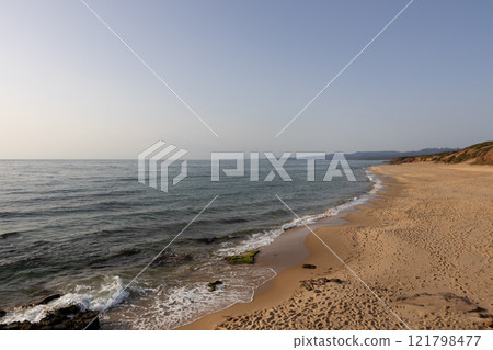 Serene Sandy Beach with Gentle Waves 121798477