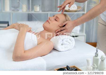 Caucasian woman enjoying relaxing anti-stress head massage. Quiescent Caucasian woman enjoying relaxing anti-stress head massage. Quiescent 121799039