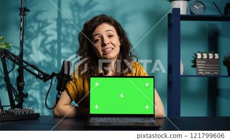 Online show host being sponsored by partnering brand to do isolated screen laptop unboxing content. Tech expert does influencer marketing, doing chroma key notebook product placement, camera B 121799606