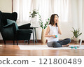 Tired woman trying to do exercise at home 121800489