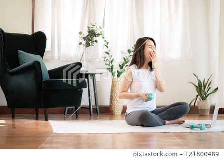 Tired woman trying to do exercise at home Tired woman trying to do exercise at home 121800489