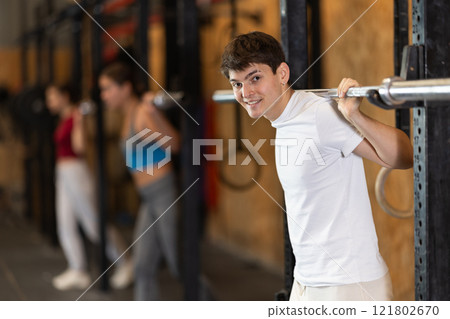 Man with a barbell in the hall Man with a barbell in the hall 121802670