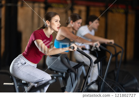 Woman training on an airbike 121802727