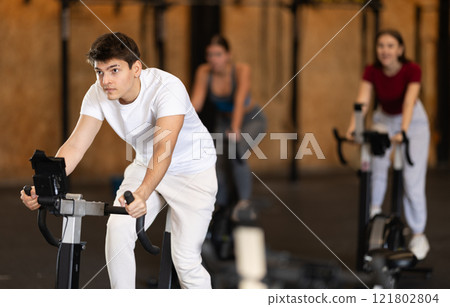 Man training on an exercise bike 121802804