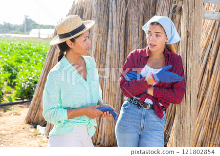 Two female workers talking Two female workers talking 121802854