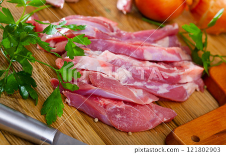 Preparation of raw turkey thigh with parsley and garlic 121802903