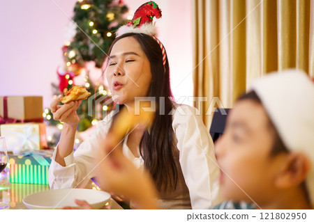 Asian family celebrate Christmas Festival together. Happy cheerful Asian family is celebrating Christmas and New Year dinner party together, a family with mother, father and son. Asian lovely family c Asian family celebrate Christmas Festival together. Happy cheerful Asian family is celebrating Christmas and New Year dinner party together, a family with mother, father and son. Asian lovely family c 121802950