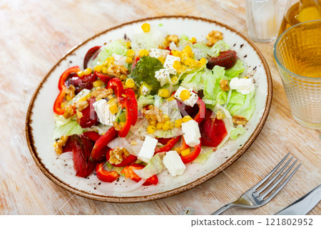 Vegetable salad with corn and bell peppers on a plate 121802952
