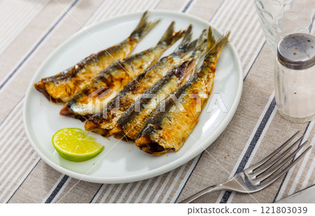 Fried sardine fish served on plate 121803039