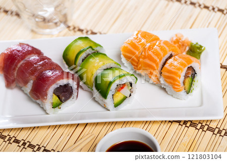 Set of urumaki rolls with salmon, tuna, avocado and crab Set of urumaki rolls with salmon, tuna, avocado and crab 121803104