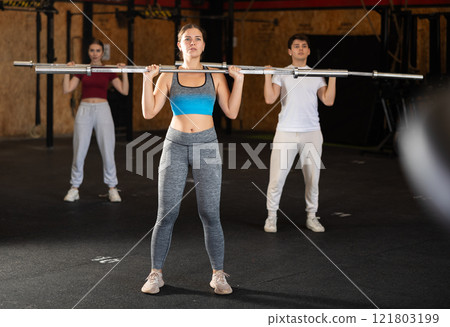 Woman in top doing barbell press 121803199