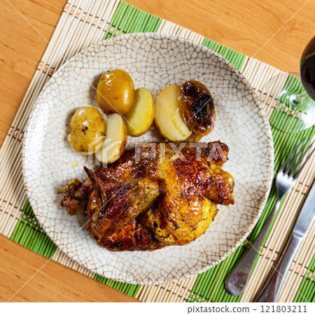 Grilled chicken piece and potatoes served in a plate Grilled chicken piece and potatoes served in a plate 121803211