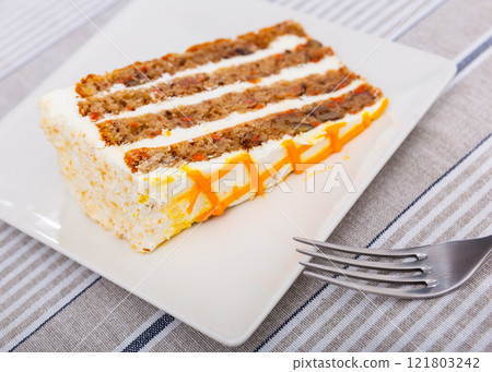 Small triangular piece of carrot cake is on plate Small triangular piece of carrot cake is on plate 121803242