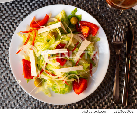 Salad with lettuce, tomatoes, onion, olives and cheese Salad with lettuce, tomatoes, onion, olives and cheese 121803302