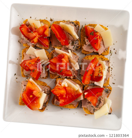 There are sandwiches canape with pate, cheese and tomato on plate. 121803364