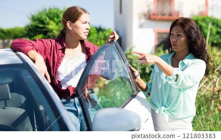 Woman showing way to young lady 121803383