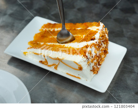 Piece of carrot cake served for dessert Piece of carrot cake served for dessert 121803404