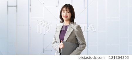 Smiling woman/businesswoman with a laptop 121804203