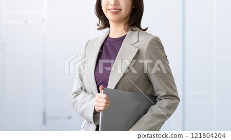 Smiling woman/businesswoman with a laptop 121804204
