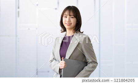 Smiling woman/businesswoman with a laptop 121804205