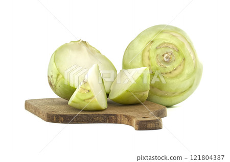 Fresh Kohlrabi Vegetable Slices on Wooden Cutting Board Isolated on White Background 121804387