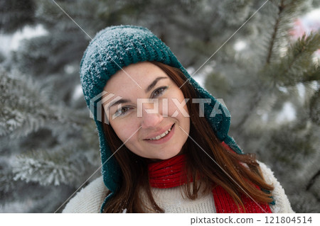 A Joyful Woman in Winter Scenery Surrounded by Snowy Trees While Wearing Cozy Apparel 121804514