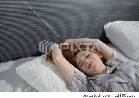 A Woman Enjoys Her Peaceful and Serene Morning in a Cozy Bed, Relishing the Calmness A Woman Enjoys Her Peaceful and Serene Morning in a Cozy Bed, Relishing the Calmness 121805153