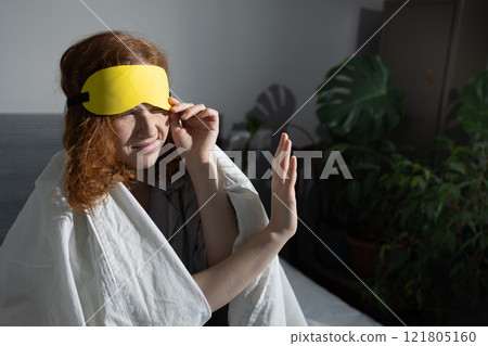 Experience ultimate comfort and relaxation with a soothing eye mask in a cozy setting Experience ultimate comfort and relaxation with a soothing eye mask in a cozy setting 121805160