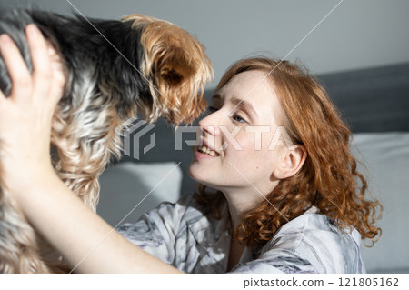 A Joyful Moment Shared Between a Woman and Her Beloved Dog in a Lovely and Cozy Setting 121805162