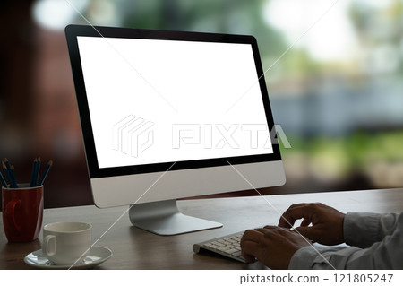 man working Laptop with blank screen on table marketing and creative design 121805247