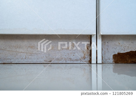 the closet with a white cabinet and a brown stain on the floor the closet with a white cabinet and a brown stain on the floor 121805269