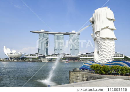 Low-angle view of the Merlion with the background of Marina Bay Sands buildings in Singapore. Merlion is the official mascot of Singapore. Low-angle view of the Merlion with the background of Marina Bay Sands buildings in Singapore. Merlion is the official mascot of Singapore. 121805556