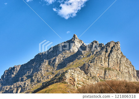 Beautiful landscape of Table Mountain below with blue sky and copy space. Peaceful and scenic view of a peak with large rocks and grass. A summit in nature ideal for adventure walks and hiking trips Beautiful landscape of Table Mountain below with blue sky and copy space. Peaceful and scenic view of a peak with large rocks and grass. A summit in nature ideal for adventure walks and hiking trips 121806318