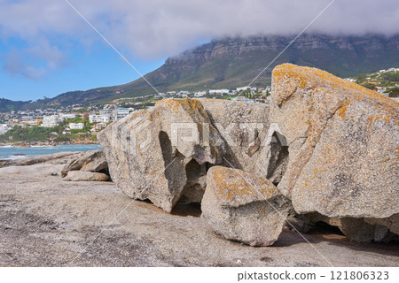 Boulders on the rocky coast of Western Cape, South Africa, Landscape view of a beautiful mountain and seashore in Cape Town. Natural seaside environment in a popular tourist location for a holiday Boulders on the rocky coast of Western Cape, South Africa, Landscape view of a beautiful mountain and seashore in Cape Town. Natural seaside environment in a popular tourist location for a holiday 121806323