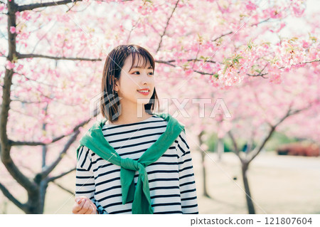 Cherry blossoms and a young woman 121807604