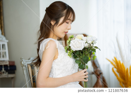 A young woman with long black hair wearing a wedding dress A young woman with long black hair wearing a wedding dress 121807636