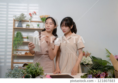 Gardeners florist at her own floral shop taking care of flowers. 121807883