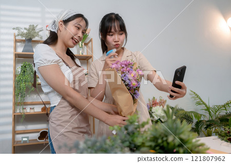 Gardeners florist at her own floral shop taking care of flowers. 121807962