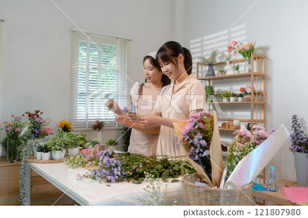 Gardeners florist at her own floral shop taking care of flowers. 121807980