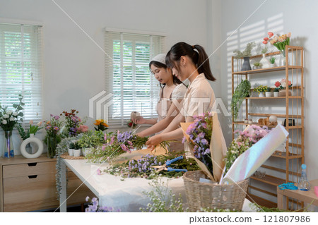 Gardeners florist at her own floral shop taking care of flowers. Gardeners florist at her own floral shop taking care of flowers. 121807986