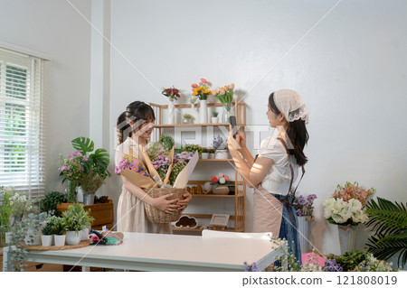 Gardeners florist at her own floral shop taking care of flowers. Gardeners florist at her own floral shop taking care of flowers. 121808019