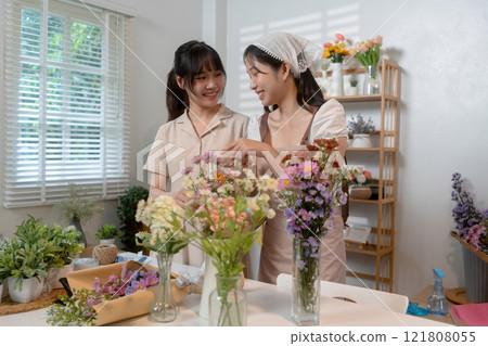 Gardeners florist at her own floral shop taking care of flowers. Gardeners florist at her own floral shop taking care of flowers. 121808055